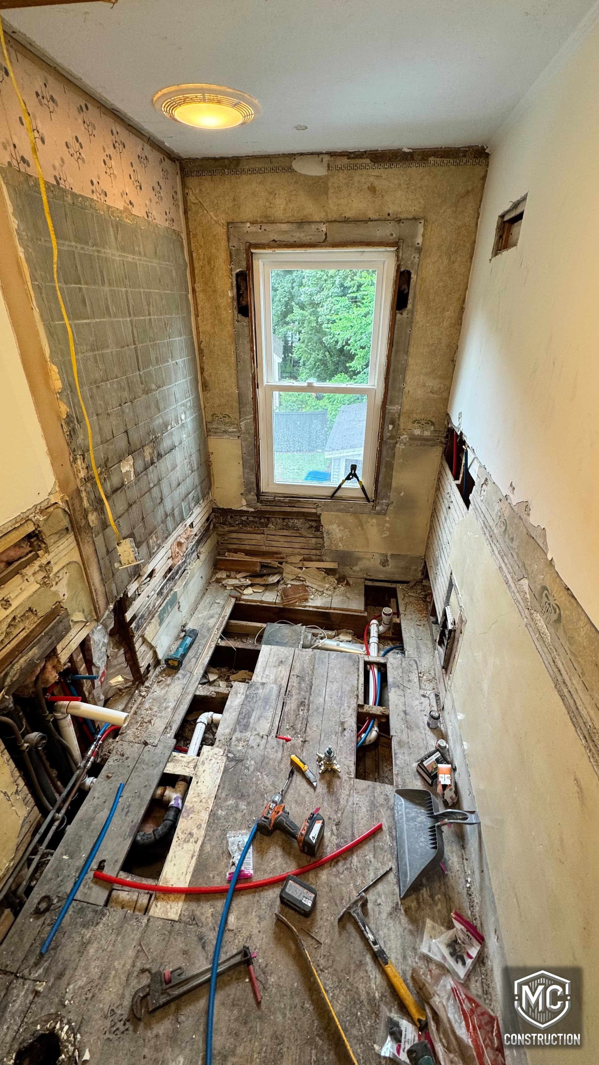 Bathroom gutted to the studs with new plumbing during renovation by MC Construction and Improvement in Natick, MA